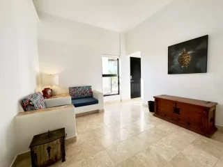 casita-2-living-room-lejos-de-todo Spacious Casita 2 living area with seating and view toward the bedroom at Lejos de Todo