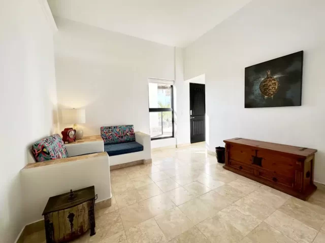 casita-2-living-room-lejos-de-todo Spacious Casita 2 living area with seating and view toward the bedroom at Lejos de Todo