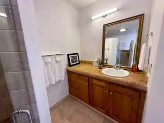 Casita 3 bathroom vanity with granite countertop and large mirror at Lejos de Todo