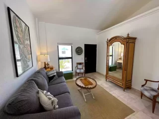 Casita 3 living room with sofa, wardrobe and bedroom view at Lejos de Todo