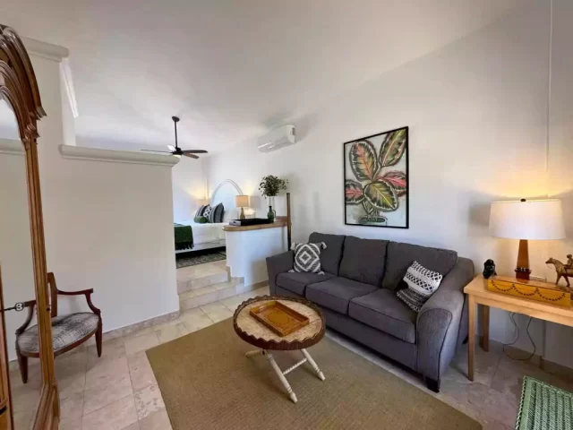 casita-3-living-room-lejos-de-todo Casita 3 living room with sofa, coffee table and bedroom area at Lejos de Todo