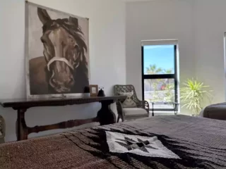 Casita 4 bedroom with decorative horse artwork and queen beds at Lejos de Todo