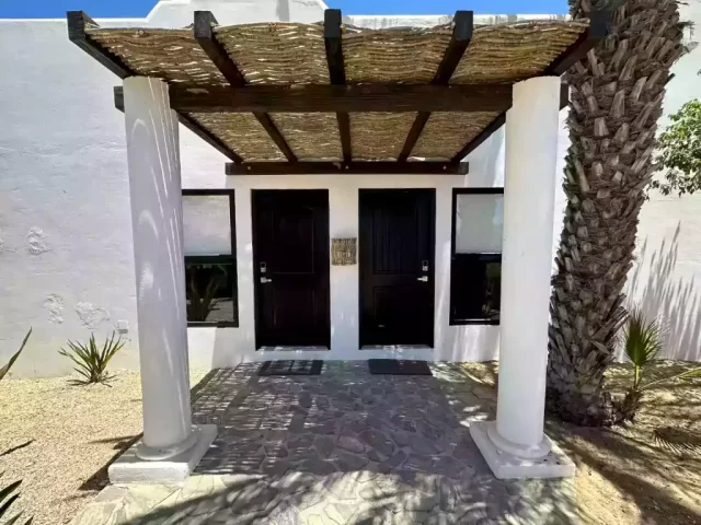 casita-4-exterior-entrance-with-two-doors-and-palm-tree-at-lejos-de-todo Casita 4 exterior entrance with two doors and palm tree at Lejos de Todo