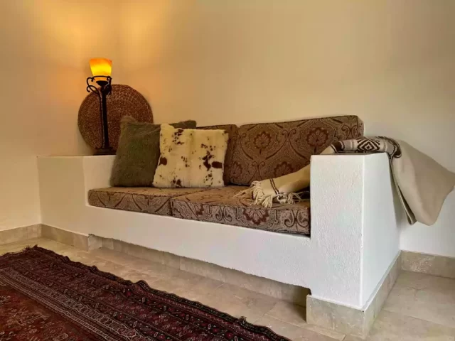 casita-4-living-area-with-built-in-sofa-and-patterned-cushions-at-lejos-de-todo Casita 4 living area with built-in sofa and patterned cushions at Lejos de Todo