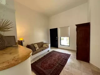 Casita 4 living room with sofa, wooden wardrobe and area rug at Lejos de Todo