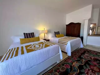 Casita 5 bedroom with two beds, yellow patterned throws