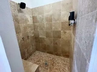 Walk-in tiled shower with rainfall showerhead at Lejos de Todo