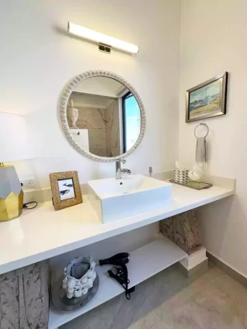 Casita 6 bathroom vanity with round mirror and sink