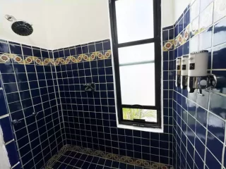 Casita 7 blue tile walk-in shower with decorative Mexican-style tile at Lejos de Todo