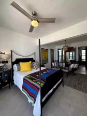 Casita 7 four-poster bedroom with colorful woven blanket and ocean view near Todos Santos