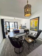 Casita 7 lounge and bedroom with wicker seating and ocean views near Todos Santos