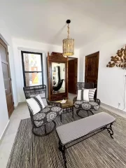 Casita 7 sitting area with wicker chairs, decorative furnishings, and a comfortable coastal interior